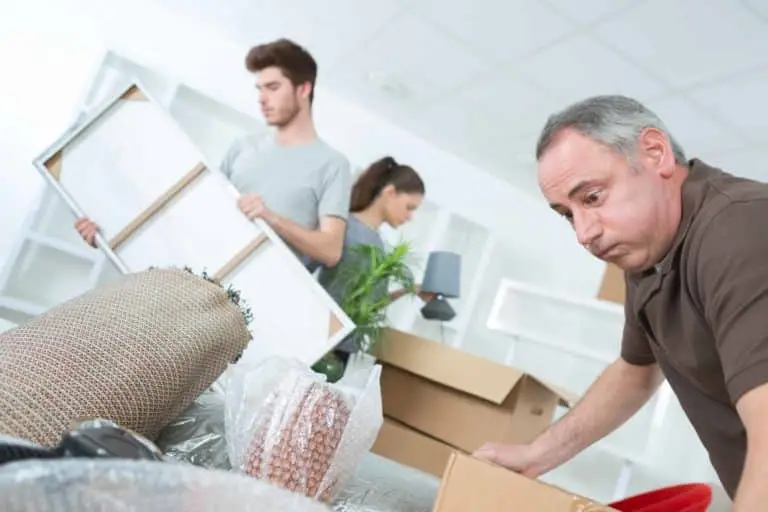 Family engaged in the process of unpacking and arranging items in a new home.