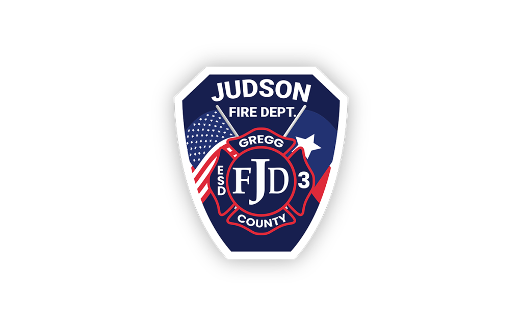 A badge logo featuring "Judson Fire Dept." at the top, an American flag on the left, a star on the right, and "FJD 3" in the center with "Gregg County ESD" encircling it. The background is navy blue with red and white elements.